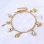 Orecchini e bracciali di tendenza con ciondoli e distanziatori con zirconia: